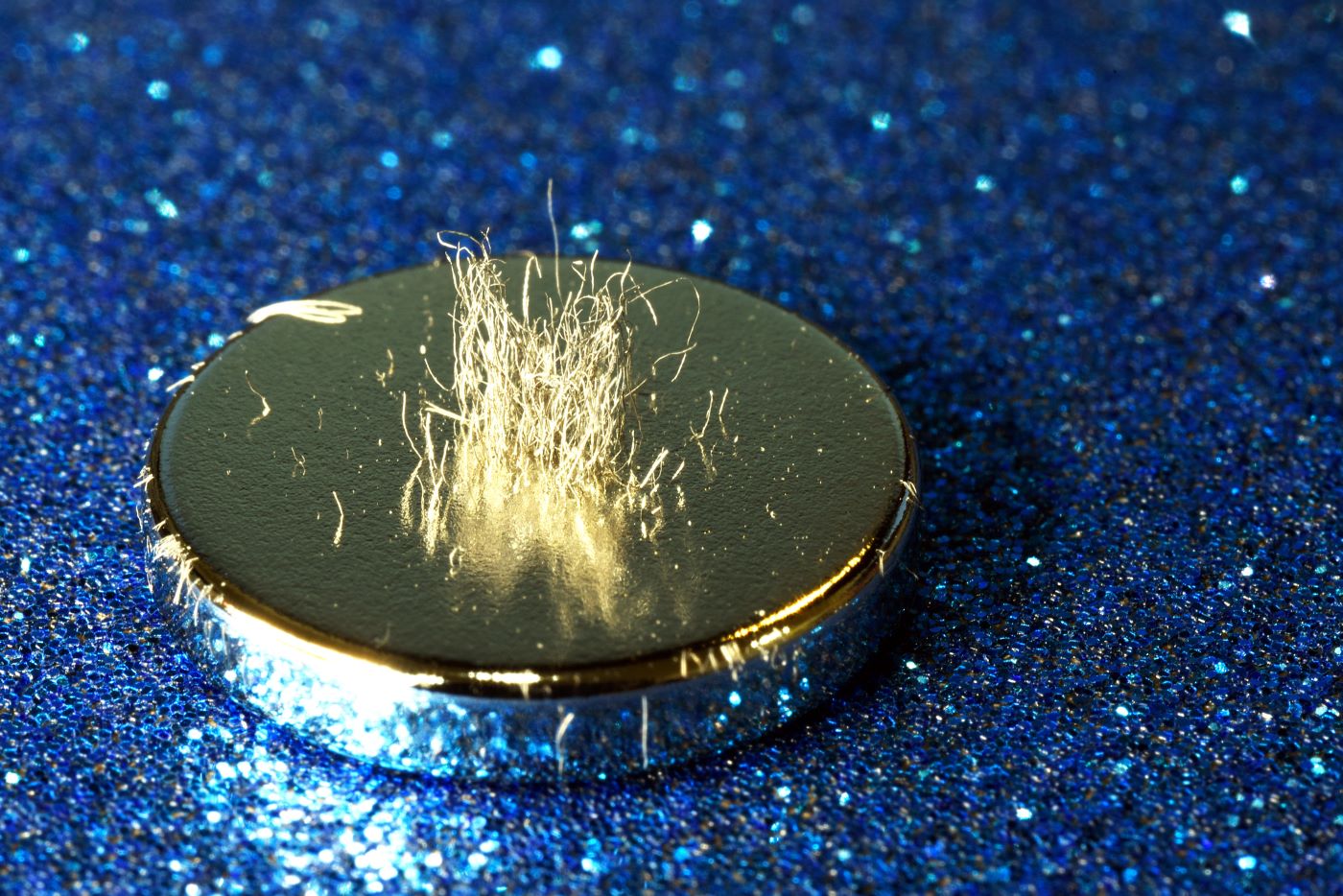 Metal shavings stand vertically atop a rare earth magnet.