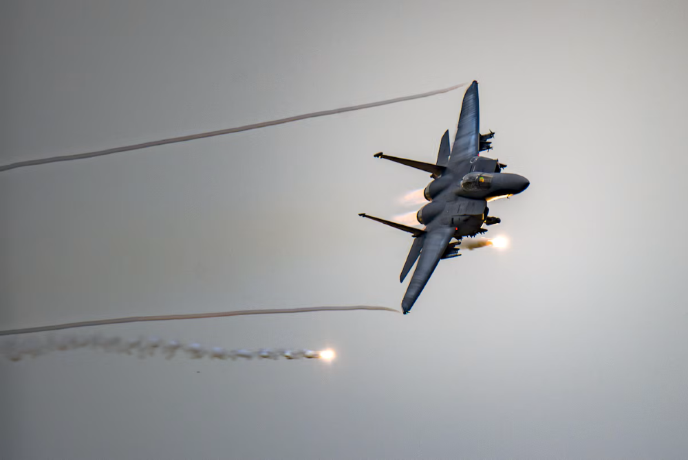 F-15E Aircraft deploying flares in the air