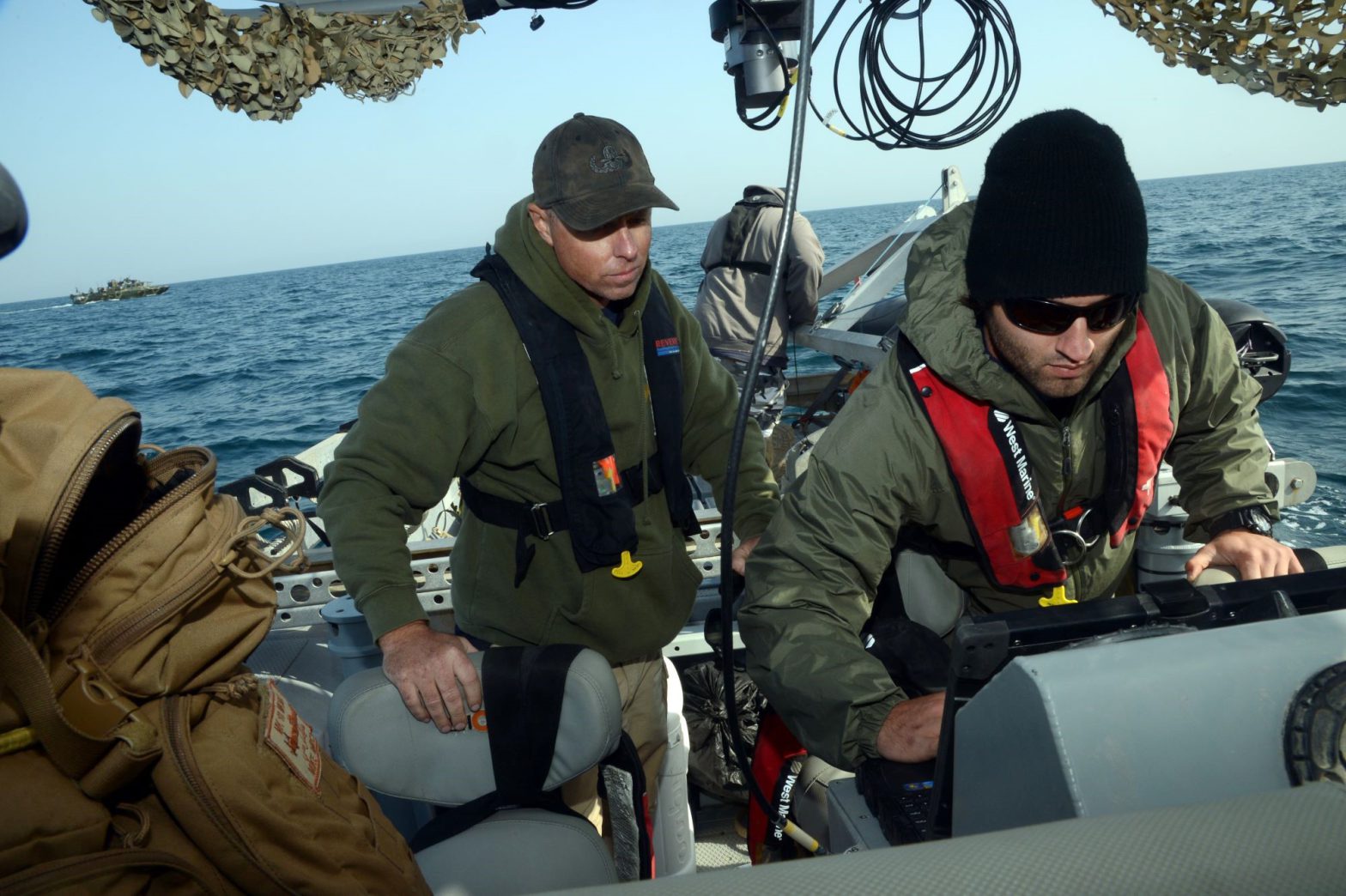 Unmanned underwater vehicle (UUV) operators in a boat