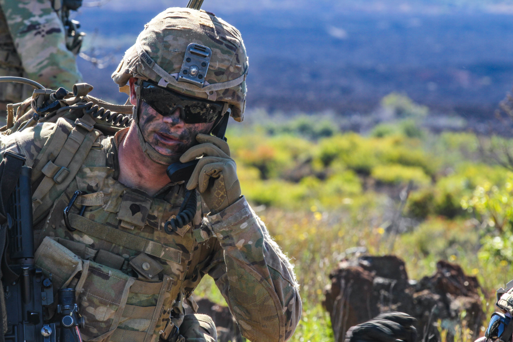 A servicemember operates communication equipment during a military exercise.