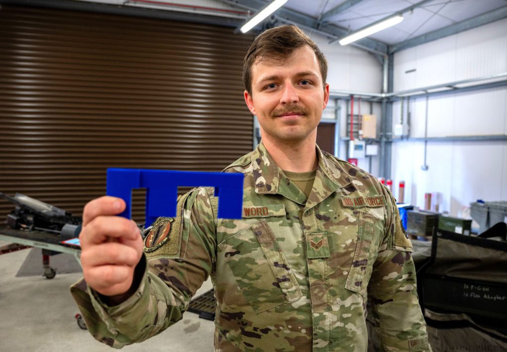 U.S. Air Force Senior Airman Devon Word, 48th Munitions Squadron conventional crew chief, holds his innovation before a 20 mm ammunition guide insert demonstration at RAF Lakenheath, England, Sept. 11, 2024. Word is working to patent the insert and make the innovation available Air Force wide. (U.S. Air Force photo by Senior Airman Renee Nicole S.N. Finona)