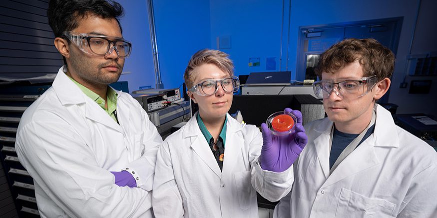 LLNL researchers, including (from left) Saptarshi Mukherjee, Johanna Vandenbrande, and Ethan Rosenberg, have introduced an innovative new approach to 3D printing using microwave energy to cure materials, opening the door to a broader range of materials than ever before (photo by Blaise Douros/LLNL).