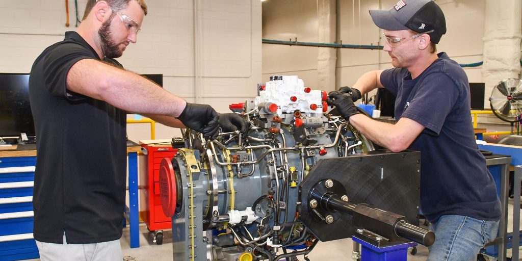 Steven Murray, left, and Dakota Martin, aircraft engine mechanics at Fleet Readiness Center East (FRCE) begin disassembly of a lift fan clutch for the F-35B Lightning II aircraft. FRCE personnel became the first within the DoD to perform a successful assembly of this component outside of Rolls Royce’s LiftWorks facility in Indianapolis (source: FRCE).