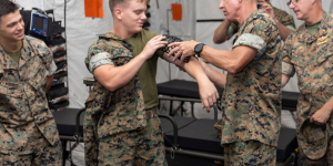 The 36th Assistant Commandant of the Marine Corps, Gen. Eric M. Smith, right, fits a 3D printed cast to the arm of Lance Cpl. Micah Mosley, a network administrator from 1st Marine Logistics Group (MLG), 1st Marine Division, I Marine Expeditionary Force (MEF), on Camp Pendleton, California, August 17, 2023. The cast was manufactured by 1st Medical Battalion. General Smith visited 1st MLG as part of a command tour and to observe the logistical capabilities of I MEF (U.S. Marine Corps photo by Sgt. Rachaelanne Woodward).