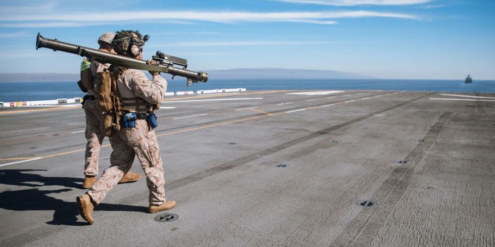 Marines assigned to Marine Medium Tiltrotor Squadron 165 (Reinforced), 15th Marine Expeditionary Unit, walk an FIM-92 Stinger man-portable air-defense system to a firing point aboard the amphibious assault ship USS Boxer while supporting a counter unmanned aerial system exercise in the Pacific Ocean, Nov. 4, 2023 (DoD News).