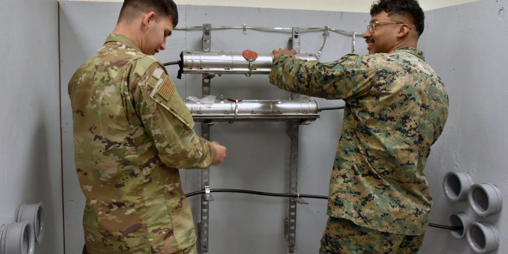 Two students at the 364th Training Squadron's Cable and Antenna Systems apprentice course use the confined space simulator Feb. 23, 2024 at Sheppard Air Force Base.