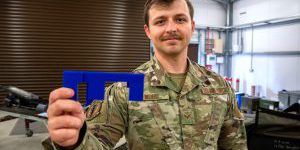 U.S. Air Force Senior Airman Devon Word, 48th Munitions Squadron conventional crew chief, holds his innovation before a 20 mm ammunition guide insert demonstration at RAF Lakenheath, England, Sept. 11, 2024. Word is working to patent the insert and make the innovation available Air Force wide. (U.S. Air Force photo by Senior Airman Renee Nicole S.N. Finona)